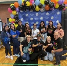 Harry Garewal with Filipino teachers and community members at a school gymnasium gathering