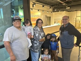 Isaac parents and community members at a food-box giveaway