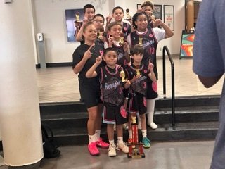 Youth team with trophy and coach